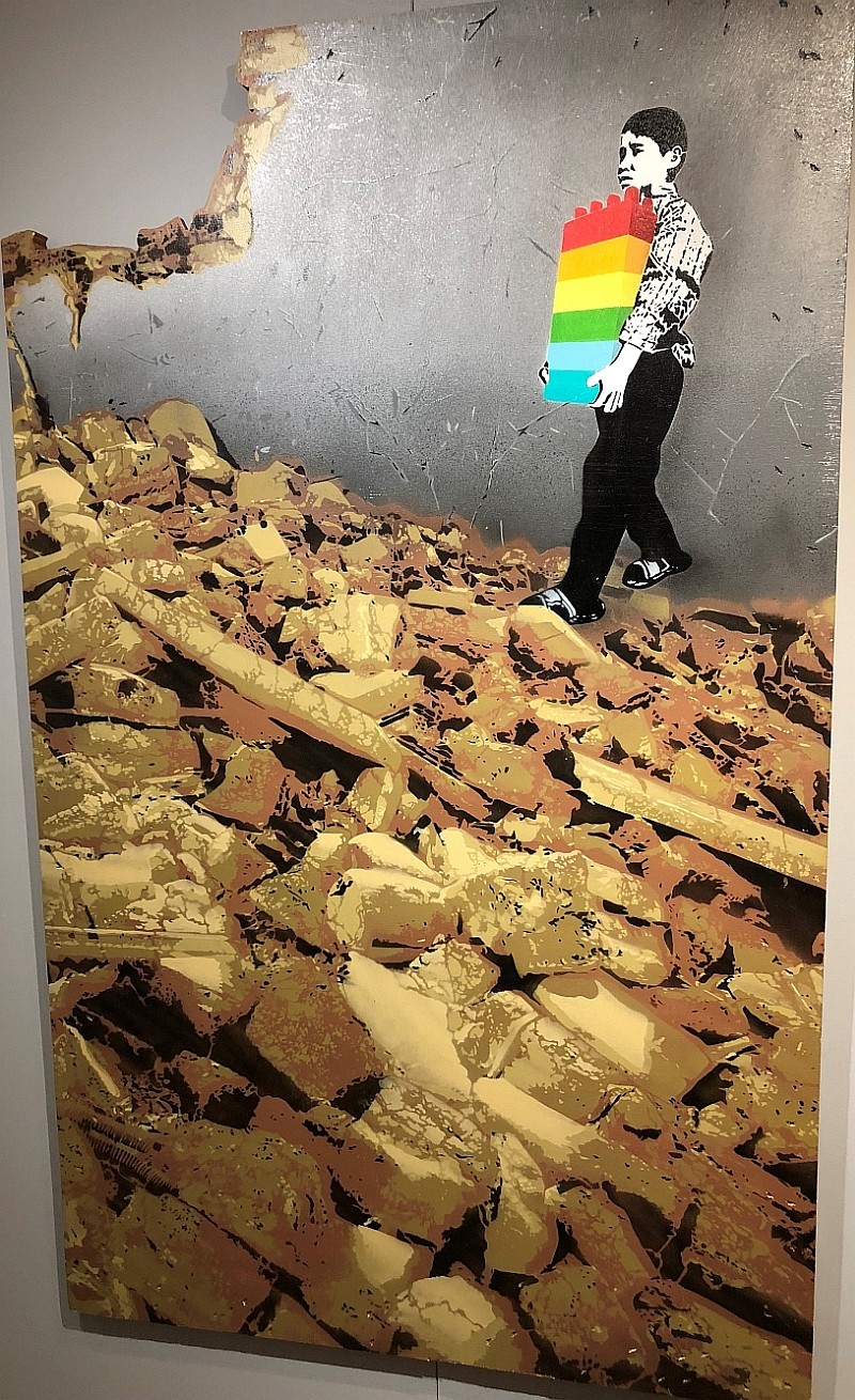 Kid carrying Lego type bricks into a tear down house.